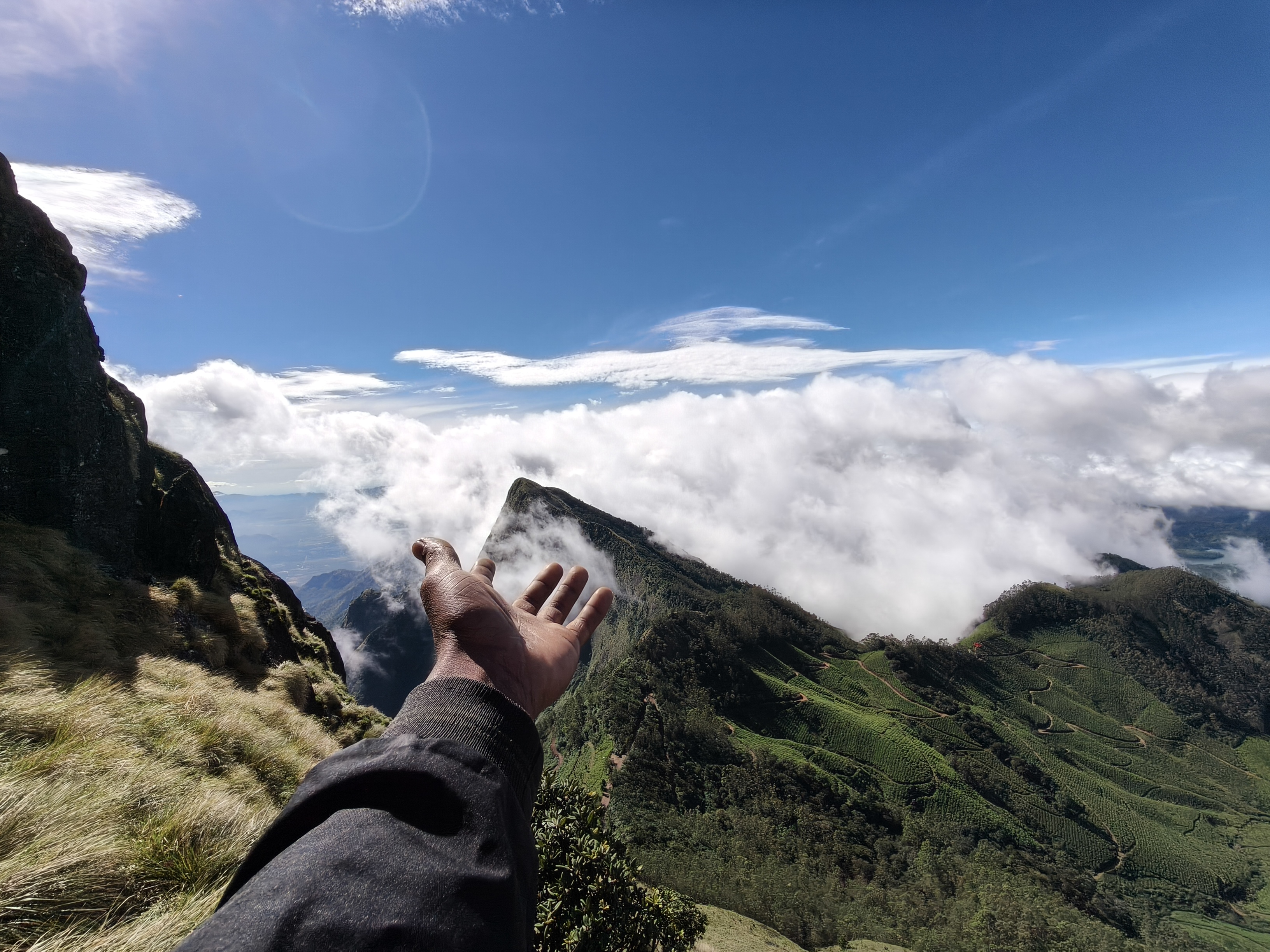 Kolukkumalai jeep safari at sunrise with mountain silhouettes and glowing sky